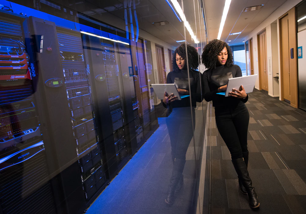 A member of staff walking through a secure server room