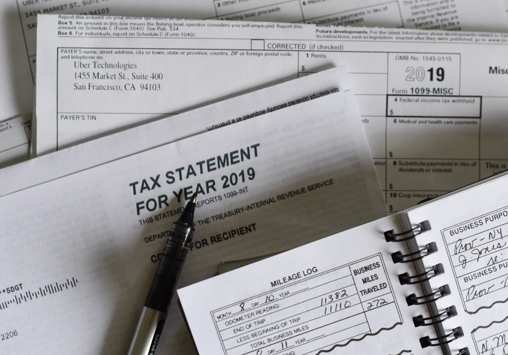 A tax statement and payroll forms on a desk